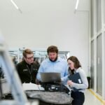 Team of engineers collaborating on a project in a modern industrial facility.